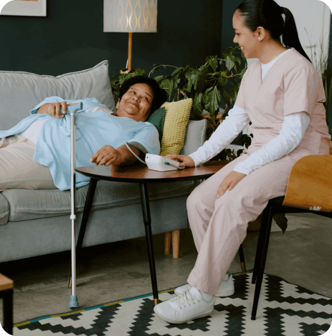 Caregiver assisting elderly woman with medication.